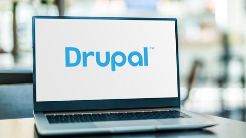 A laptop with a drupal logo